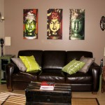 Living room scene with three Buddhas highlighted above the sofa