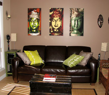 Living room scene with three Buddhas highlighted above the sofa