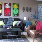 Living room scene highlighing the three Buddha paintings over the sofa