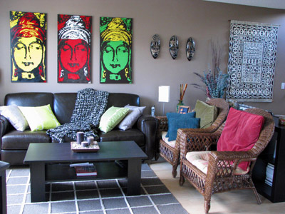 Living room scene highlighing the three Buddha paintings over the sofa